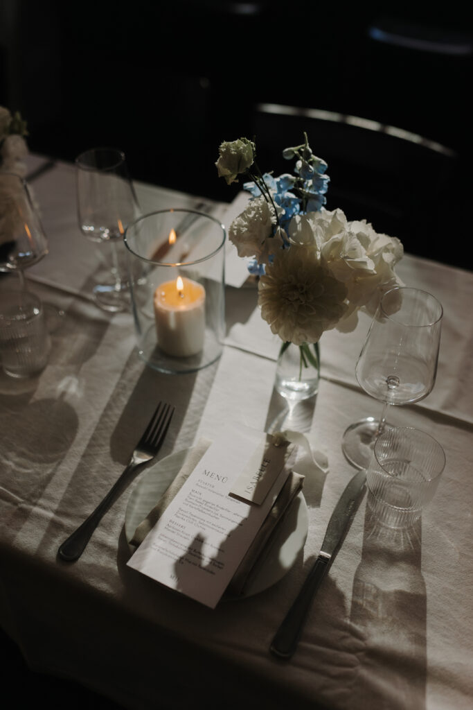 Close-up of an elegant table decoration with candles and flowers at a wedding venue in Hamburg