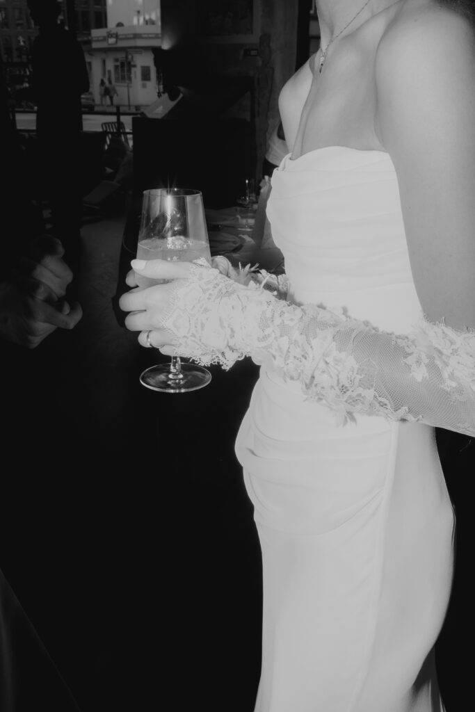 Bride with champagne glass in a stylish wedding venue in Hamburg during the celebration